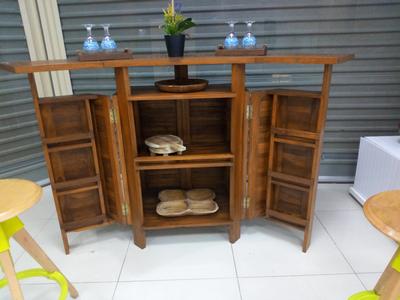 Bar with a table that can be opened and closed and storage inside and on the door as a shelf, made of teak wood which is suitable for indoor and outdoor.