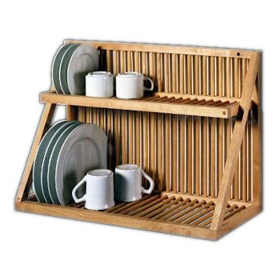 Wooden dish rack wall with a few cups and plates on it.