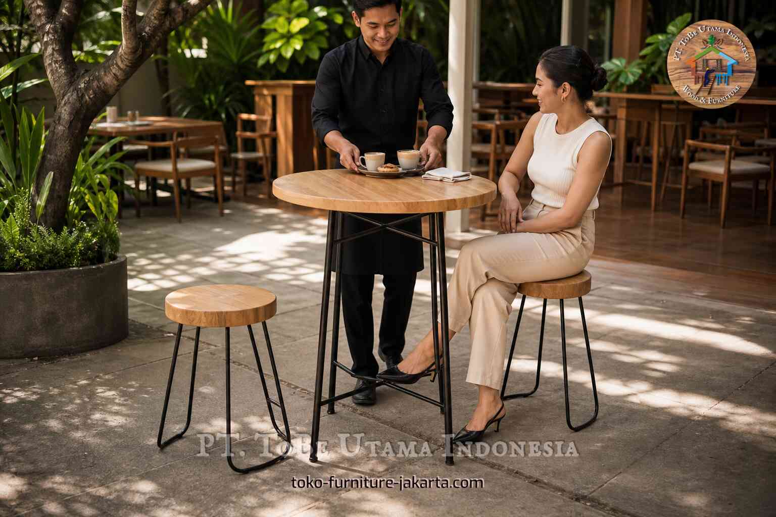 Round bar-height cafe table with stools in an outdoor cafe