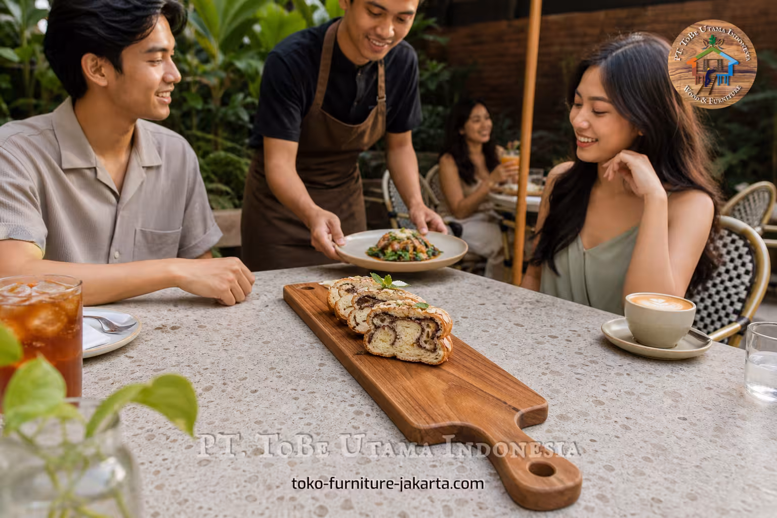 Handled wooden cutting board with sliced pastry on an outdoor cafe table as guests dine nearby